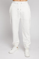 A model wearing the tapered fit joggers for men in white.