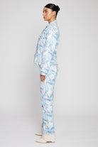 Side profile of a model showing the tapered waist fit of the psychedelic denim jacket.