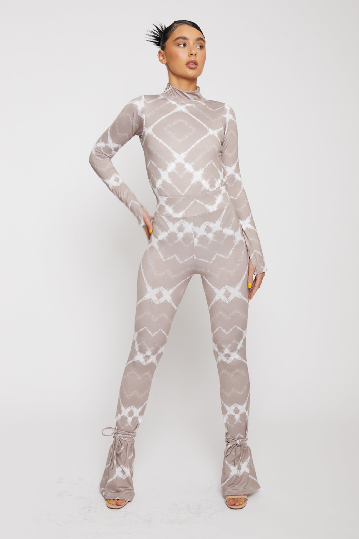 Front close-up of the taupe and white printed flare leggings for women.