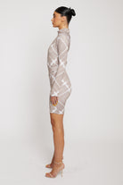 Side profile of a model showing the fit of the taupe cycling shorts.