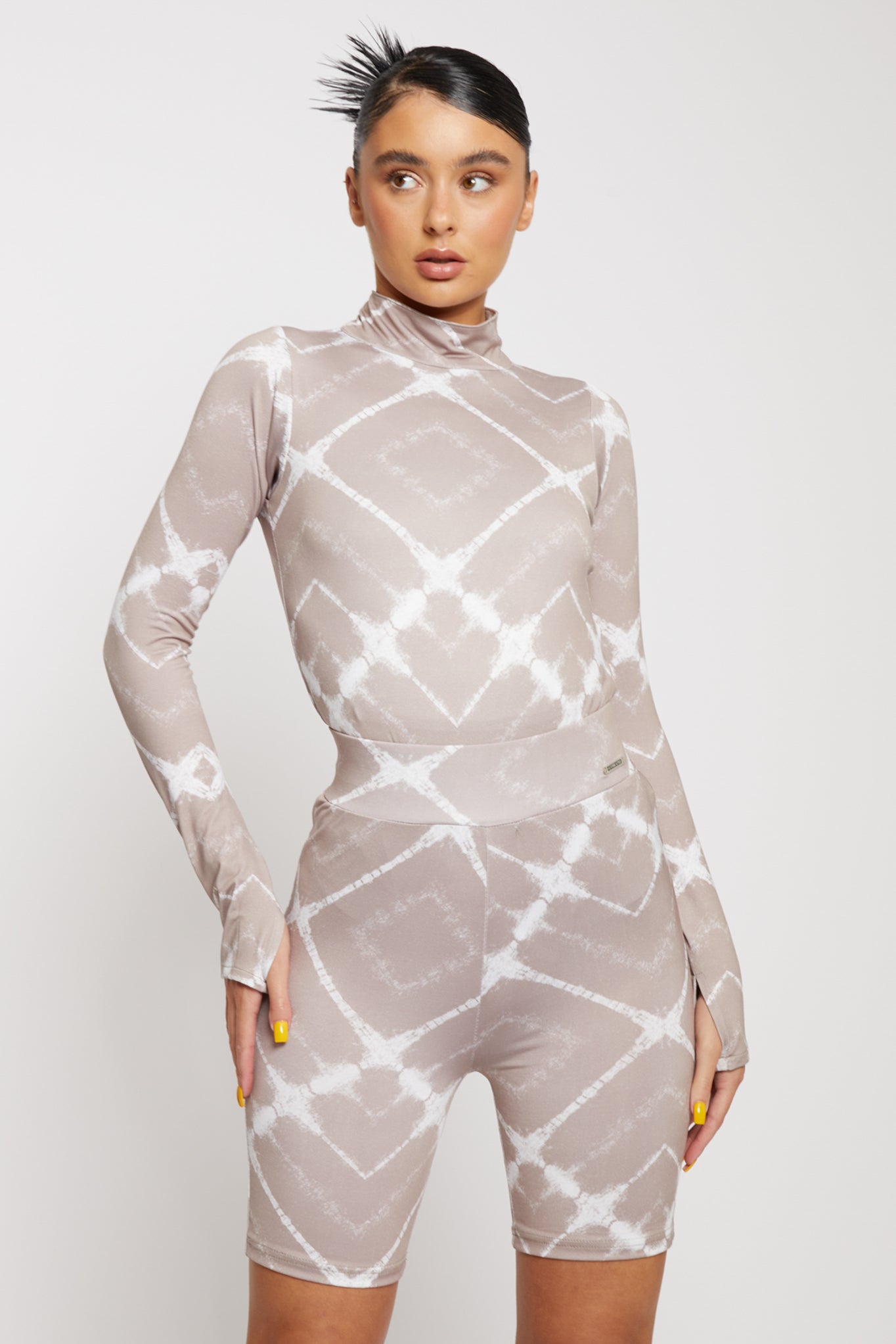 Close-up of the women's taupe printed cycling shorts showing the diamond pattern.