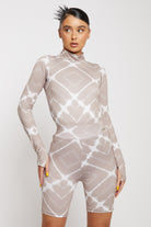 Close-up of the women's taupe printed cycling shorts showing the diamond pattern.