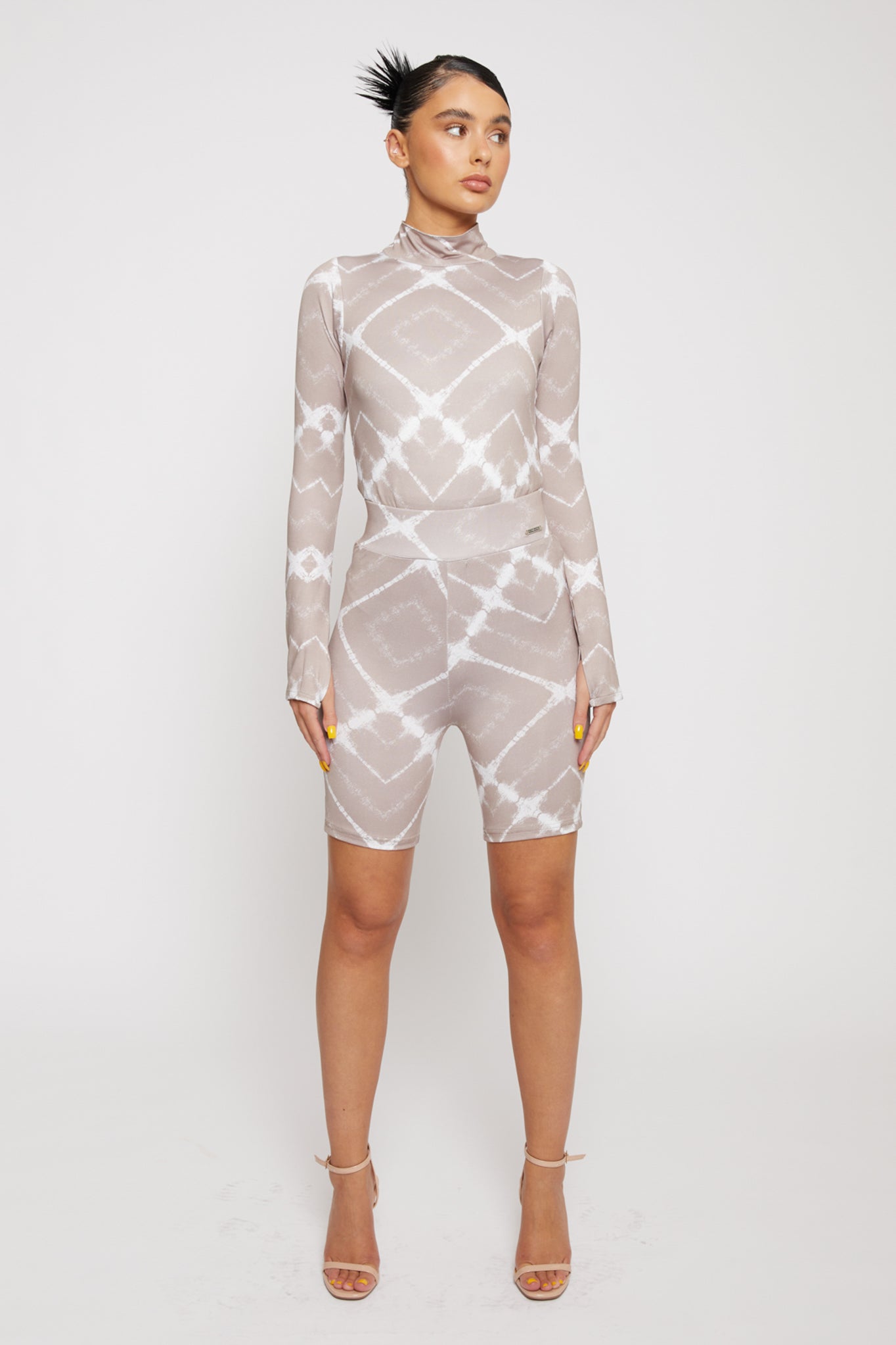 Full view of a model wearing the taupe printed cycling shorts co-ord set.