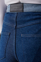 Close-up of the back pockets and logo patch on the two-tone jeans.