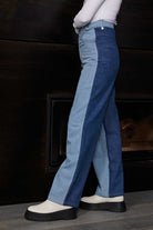 Side view of a model wearing the two-tone half wash panel jeans.