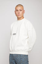 Close up detail of the black HERMAN logo on white mens crewneck sweatshirt