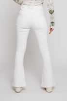 Close-up back view of the white stretch denim flare jeans.