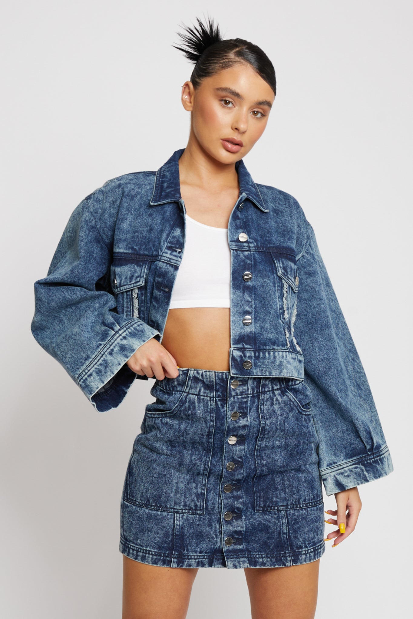 Close-up of a model in the wide sleeve cropped denim jacket.