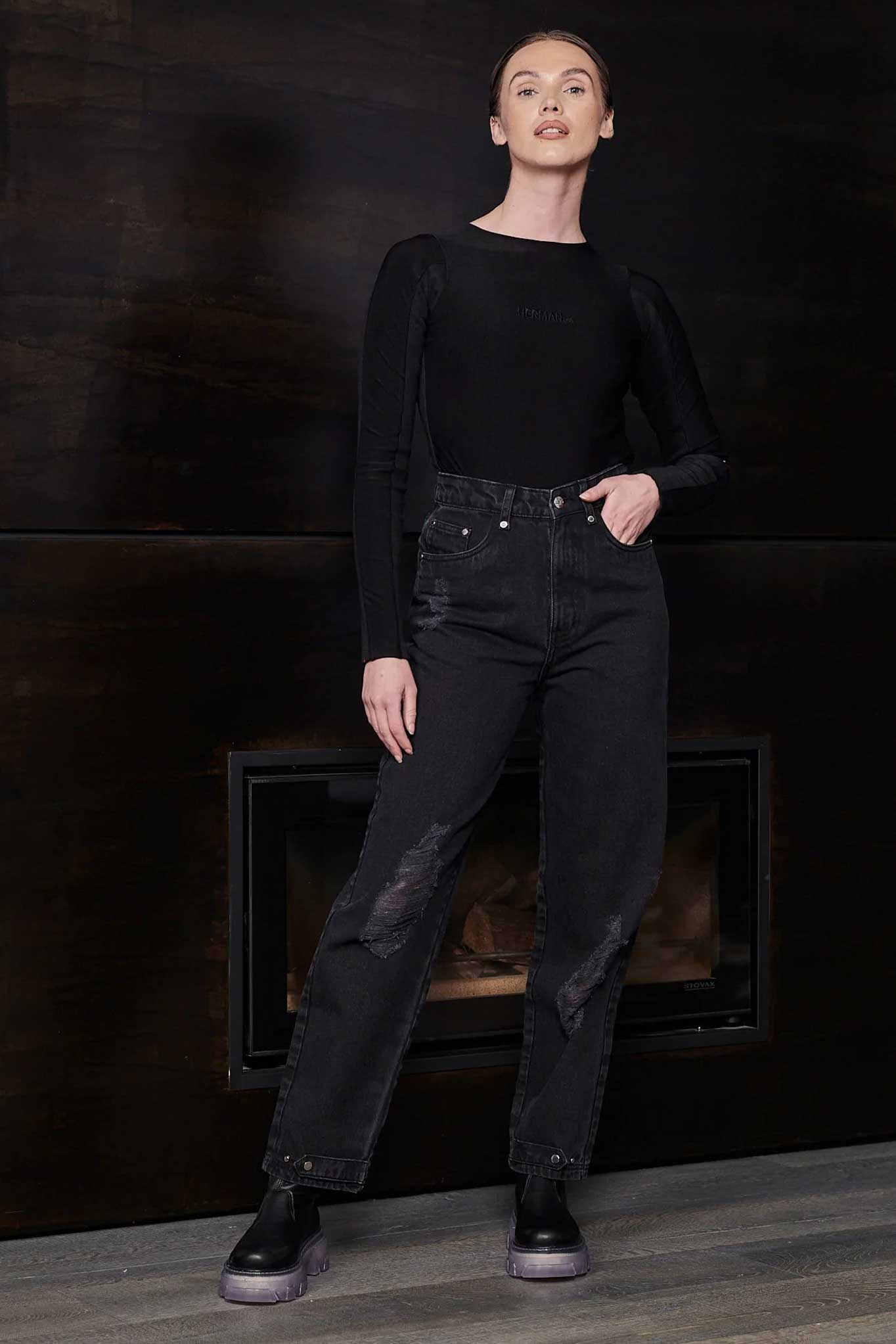 Full view of a model wearing the women's black bodysuit with jeans.