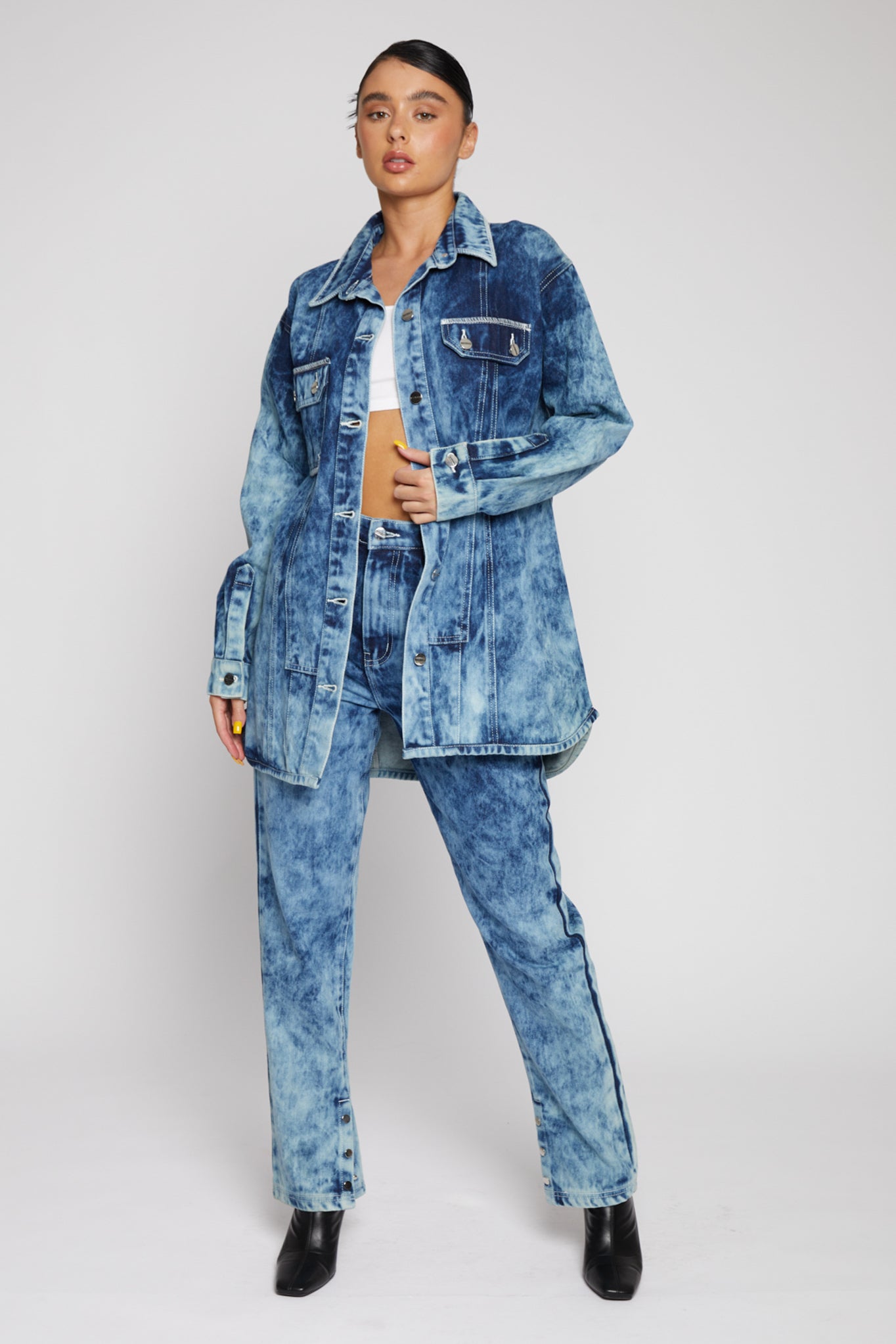 A model wearing the women's bleach wash denim shirt with matching jeans.