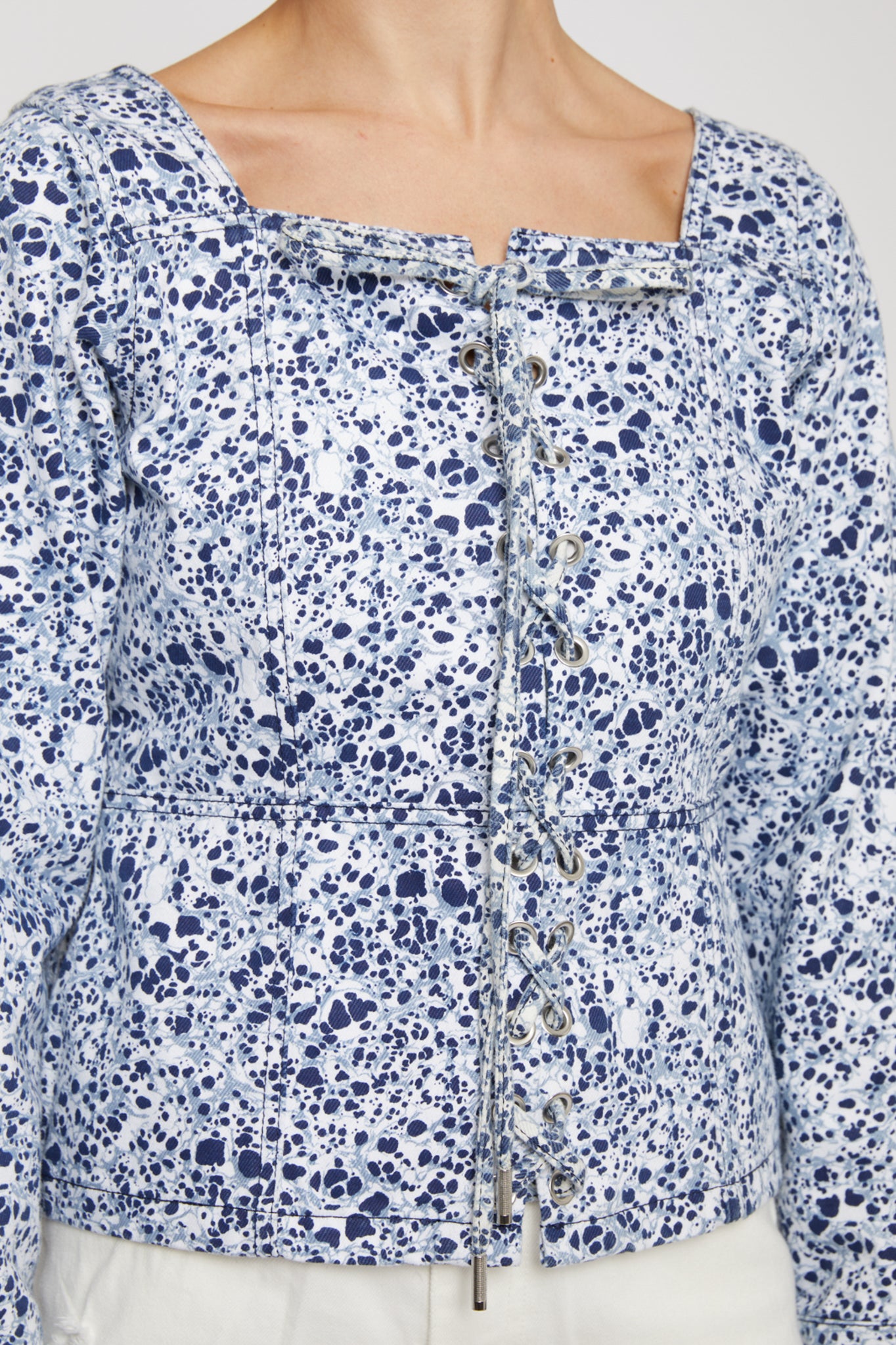 Close-up of the women's blue and silver marble print top.