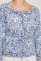 Close-up of the women's blue and silver marble print top.