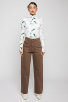 Front view of a model in the women's brown wash wide-leg jeans.