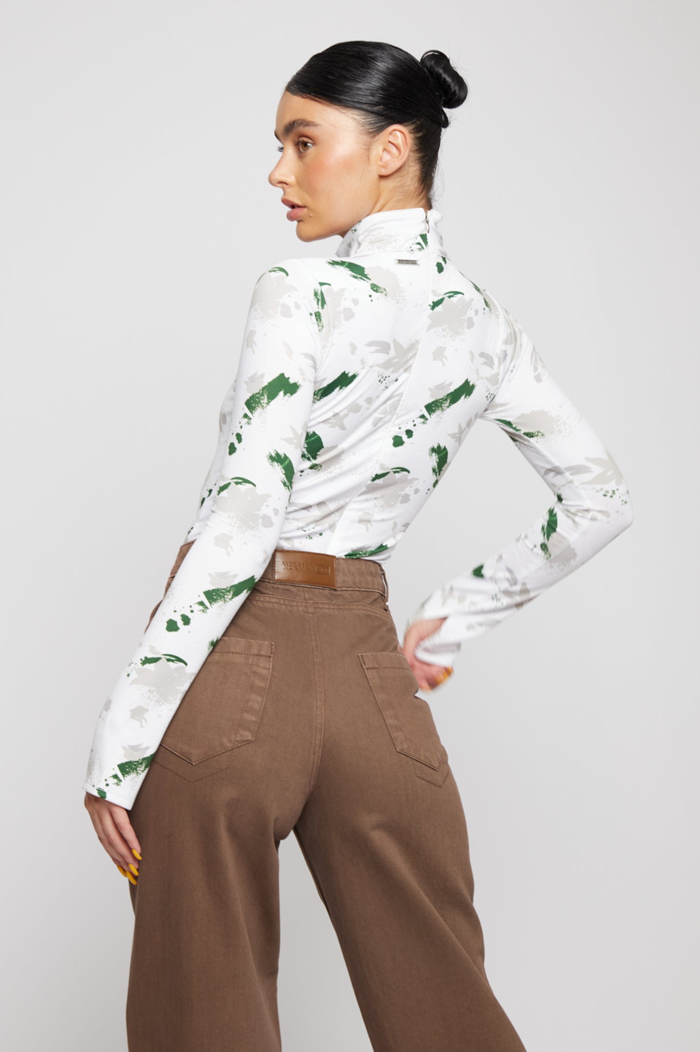 Angled back view of the women's brown wide-leg jeans.