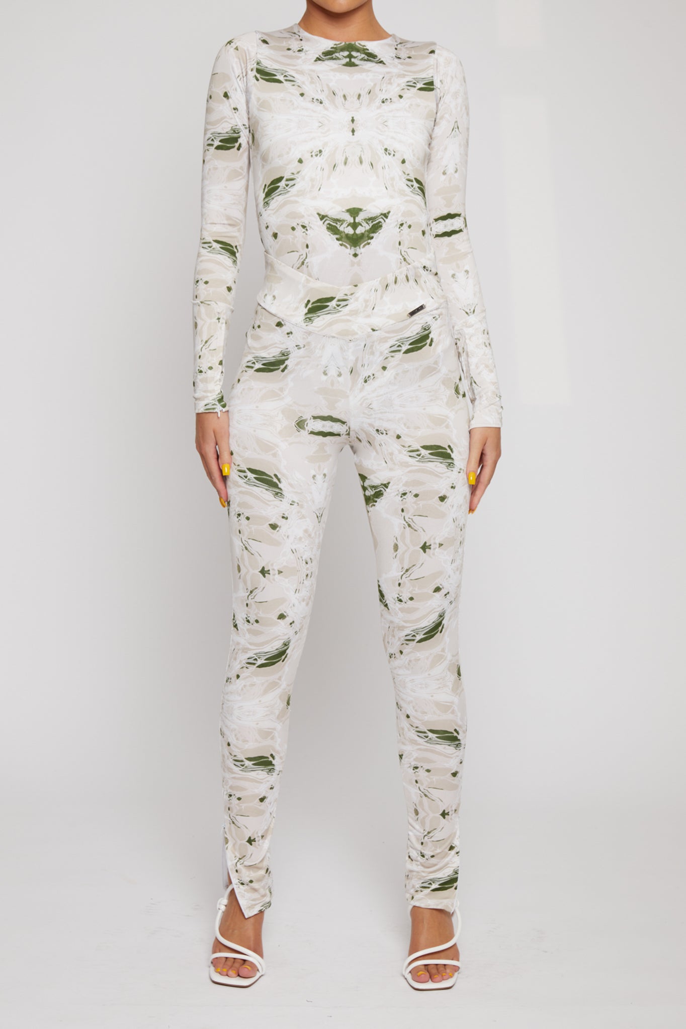 A model wearing the women's printed dipped leggings with the matching top.