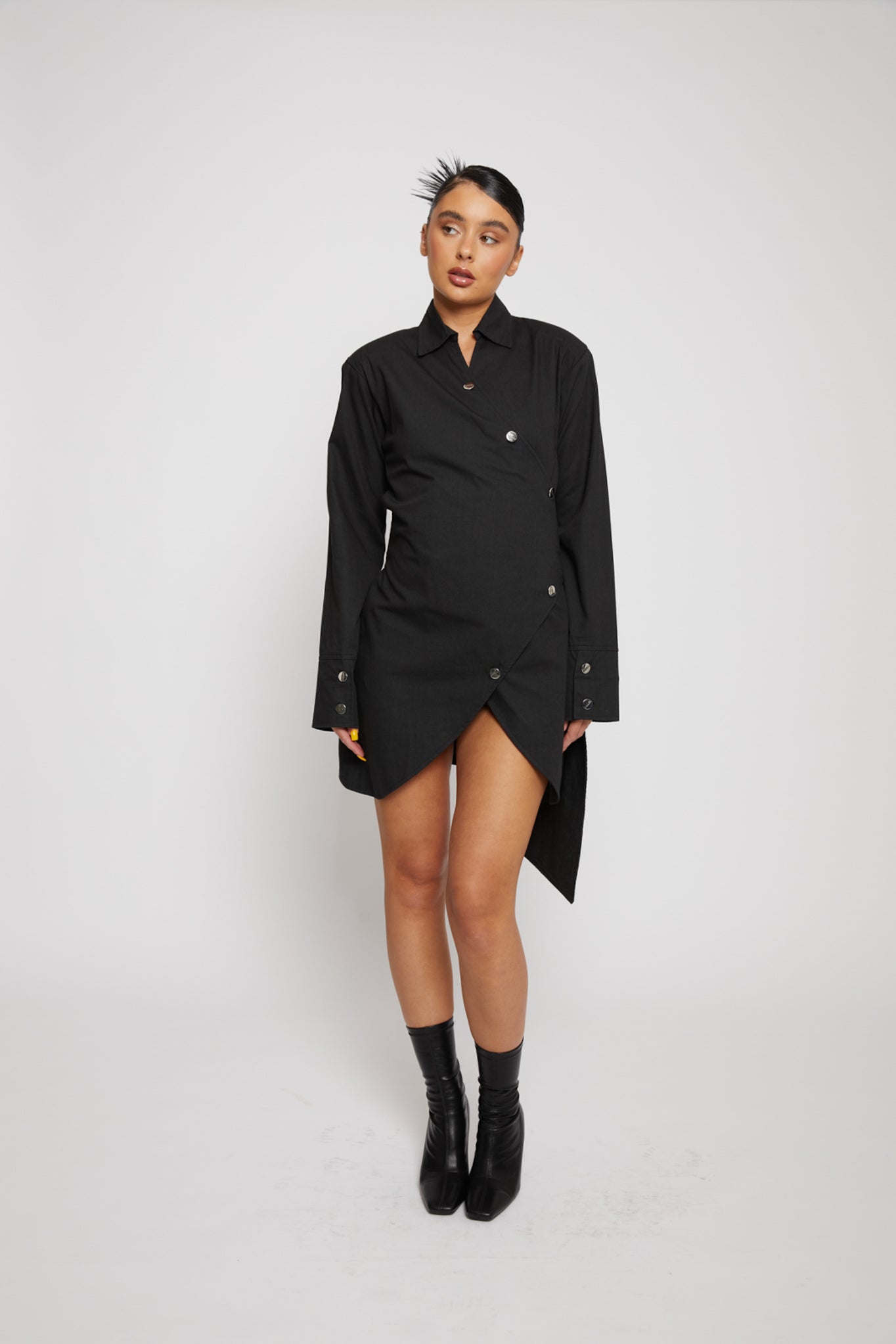 Full view of a model wearing the women's asymmetric shirt dress.
