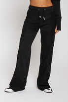 Front view of model wearing black kroen joggers with a matching hoodie