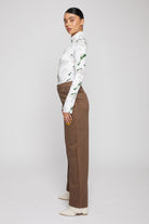 Side view of the women's brown baggy denim jeans.