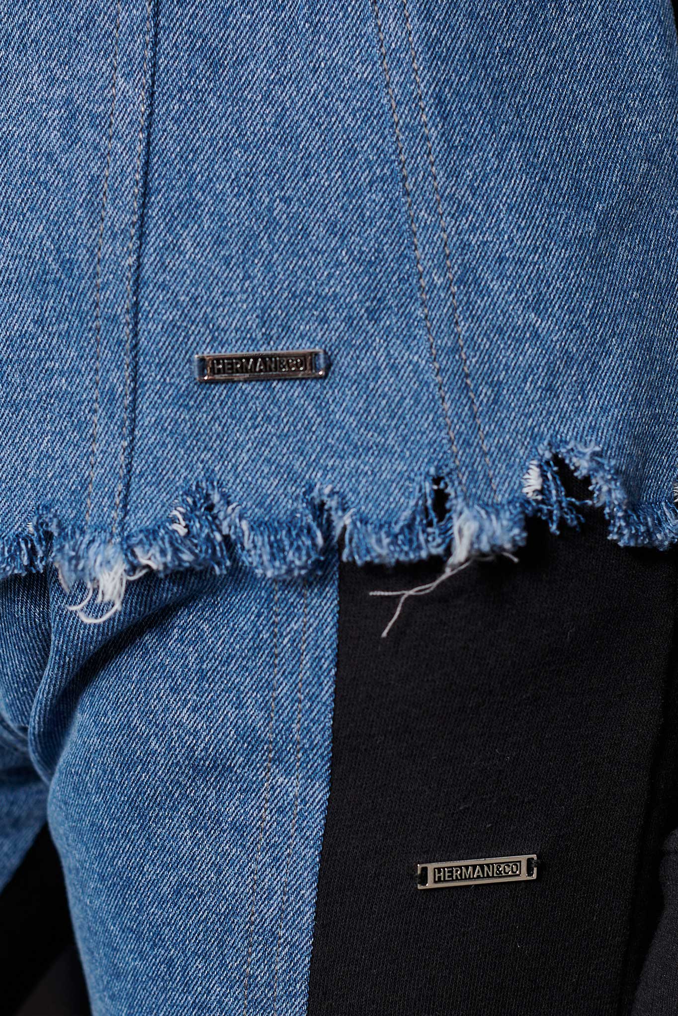 Detailed view of the frayed denim hem on the women's denim and fleece jacket.