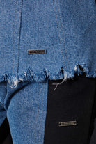 Detailed view of the frayed denim hem on the women's denim and fleece jacket.