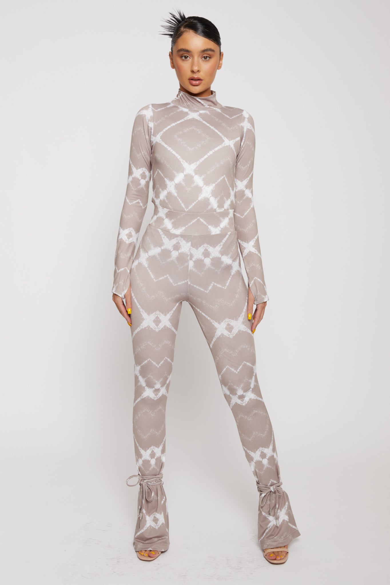 A model wearing the women's printed flare leggings with a matching long-sleeve top.