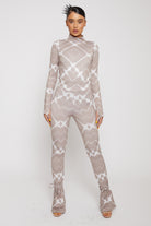 A model wearing the women's printed flare leggings with a matching long-sleeve top.