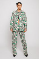 A model styled in the women's psychedelic print jeans with a matching jacket.