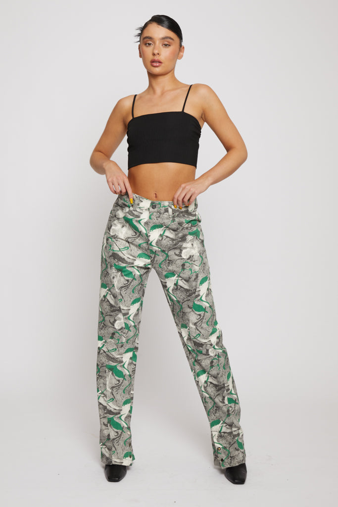 Front view of a model wearing the women's psychedelic print straight-leg jeans.