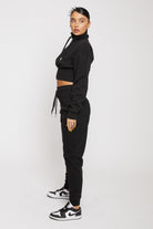 Side profile of the women's black tapered joggers showing the slim fit