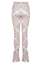 Front view of the women's white and taupe flare pant laid flat.